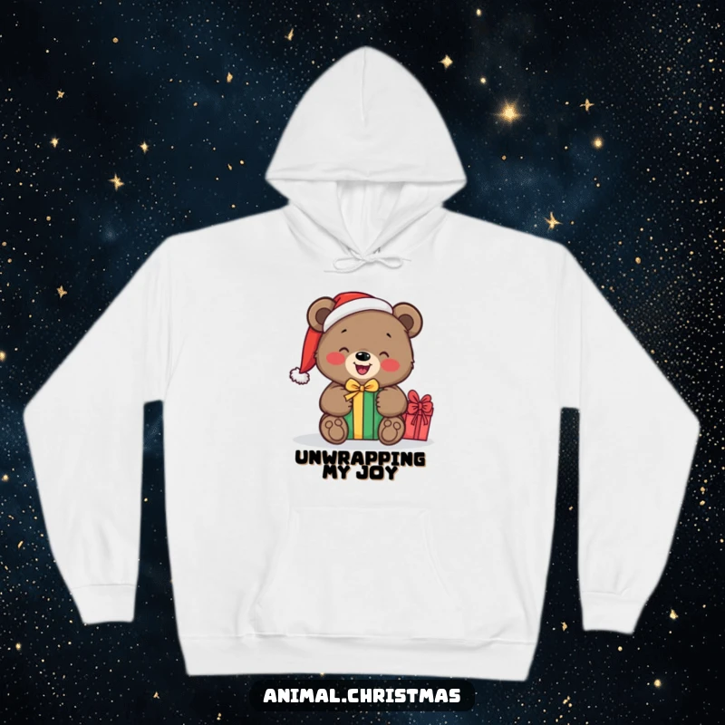 Funny hoodie of a bear wearing a Santa hat, excitedly unwrapping a gift, bringing a sense of festive joy and warmth.