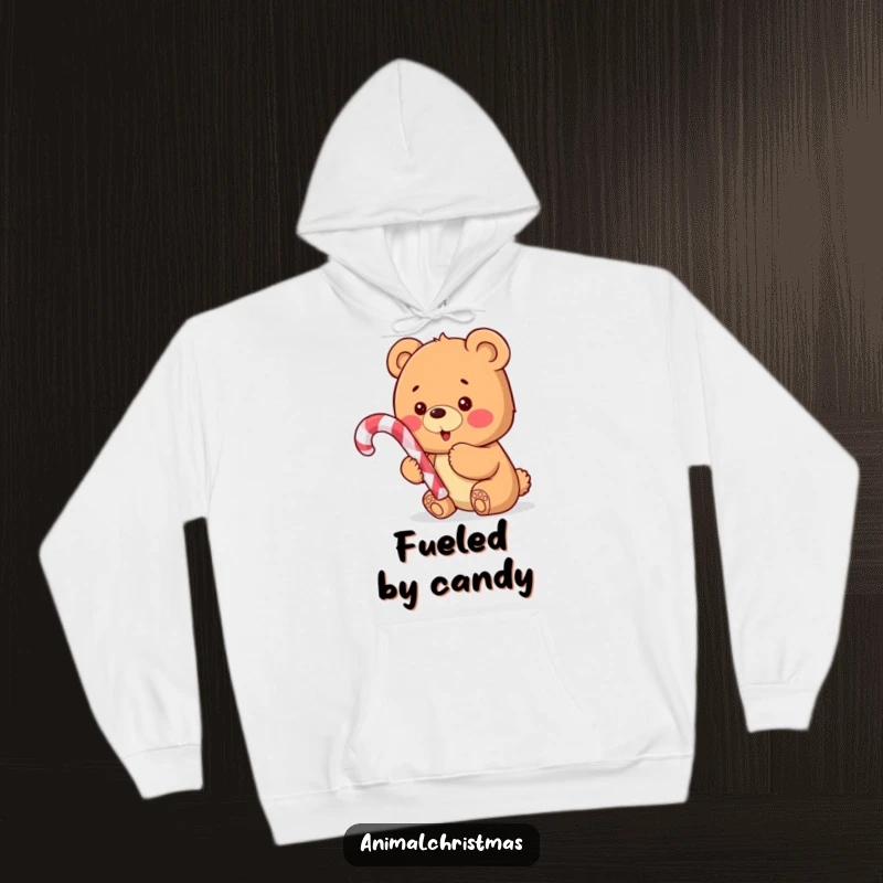 Funny hoodie depicting a sweet bear cub holding a candy cane, looking thrilled and ready for holiday fun.