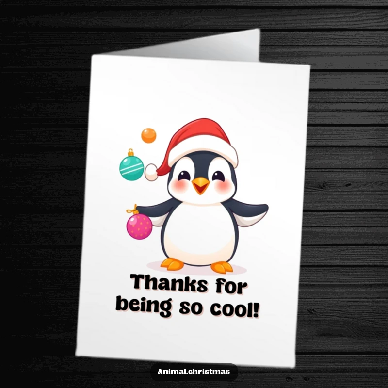 Funny free printable thank you card depicting a penguin in a Santa hat juggling ornaments, a cheerfully festive expression of thanks.