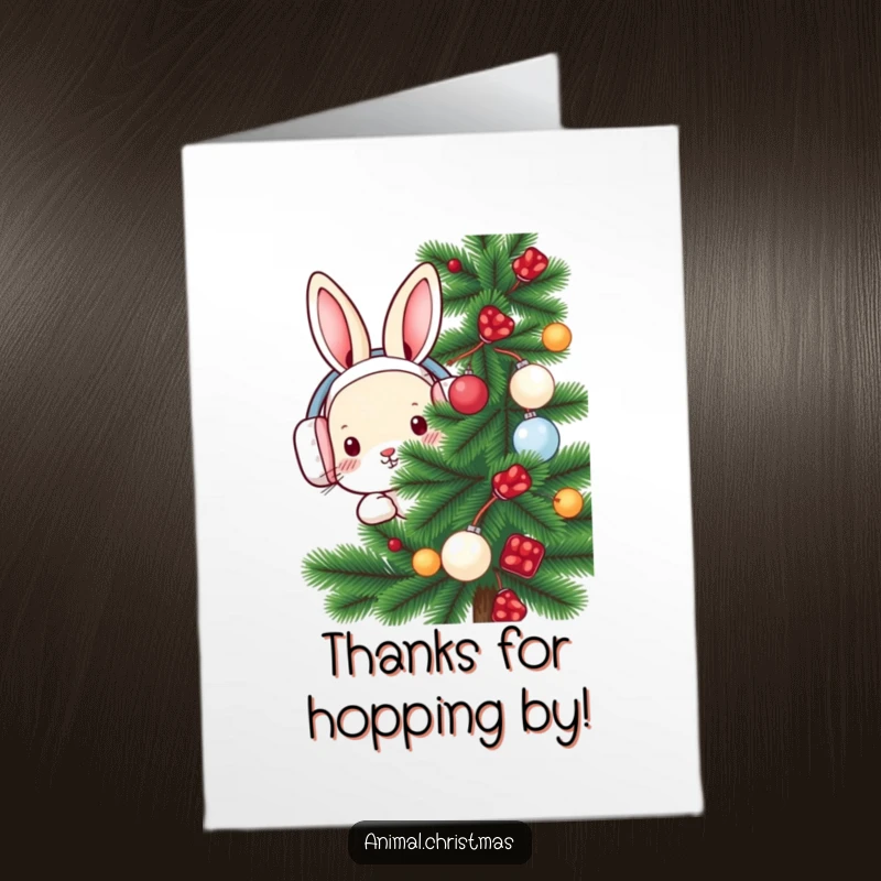 Funny Free Printable Thank You Card: A rabbit wearing earmuffs peeks from a snowy pine tree, expressing gentle thanks.