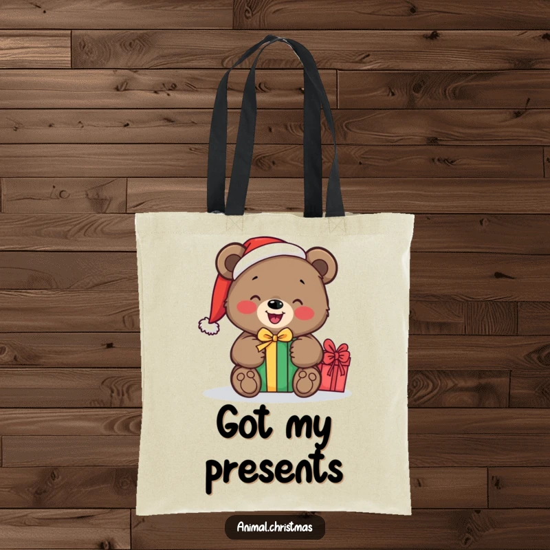 Funny tote bag displaying a bear with a Santa hat, happily unwrapping a gift, ideal for festive shopping trips.